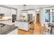Spacious kitchen featuring hardwood floors, a kitchen island with barstool seating, and stainless appliances at 203 Witheridge Ct, Apex, NC 27502