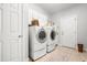 Functional laundry room with washer, dryer, and ample storage space at 203 Witheridge Ct, Apex, NC 27502