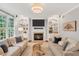 Bright living room features a fireplace, built-in shelving, and neutral tones at 203 Witheridge Ct, Apex, NC 27502