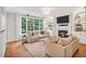 Cozy living room with built-in shelves, fireplace, and hardwood floors at 203 Witheridge Ct, Apex, NC 27502