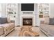 Inviting living room featuring a fireplace and custom built-in shelving at 203 Witheridge Ct, Apex, NC 27502
