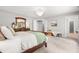 Spacious main bedroom with a chandelier, wood furnishings, and natural light, for relaxation at 203 Witheridge Ct, Apex, NC 27502