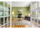 Stylish home office with green walls, hardwood floors, and ample workspace at 203 Witheridge Ct, Apex, NC 27502