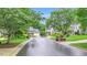 Street view of beautiful homes and green spaces in a well-maintained, landscaped neighborhood at 203 Witheridge Ct, Apex, NC 27502