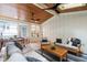 Bright sunroom with a wood ceiling, ceiling fans, and lots of windows offering views of the outdoors at 203 Witheridge Ct, Apex, NC 27502