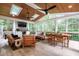 Bright and airy sunroom with wood ceiling, skylights, and ample seating at 203 Witheridge Ct, Apex, NC 27502