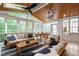 Inviting sunroom featuring a wood ceiling, ceiling fans, and lots of windows offering views of the outdoors at 203 Witheridge Ct, Apex, NC 27502