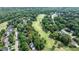 Aerial view features a neighborhood with mature trees, golf course and single Gathering homes at 204 Muirfield Ln, Clayton, NC 27527