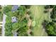 Aerial view of a neighborhood featuring lush trees, a golf course, and single-Gathering homes at 204 Muirfield Ln, Clayton, NC 27527