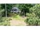 Backyard and home is surrounded by lush greenery and mature trees at 204 Muirfield Ln, Clayton, NC 27527