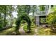 Scenic backyard featuring a stone walkway arching through the meticulously landscaped yard at 204 Muirfield Ln, Clayton, NC 27527