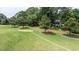 Backyard leads to golf course with mature trees and lush green grass at 204 Muirfield Ln, Clayton, NC 27527