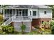 Backyard view of deck with lush landscaping with brick foundation at 204 Muirfield Ln, Clayton, NC 27527