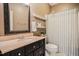 Neutral-toned bathroom featuring a vanity with black cabinetry and a shower with a curtain at 204 Muirfield Ln, Clayton, NC 27527