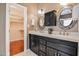 Bathroom with a double sink vanity and a glimpse into the spacious closet at 204 Muirfield Ln, Clayton, NC 27527