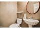 This bathroom has a decorative sink and toilet with bronze accents at 204 Muirfield Ln, Clayton, NC 27527
