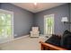 Cozy bedroom features two windows and a comfortable chair and futon at 204 Muirfield Ln, Clayton, NC 27527