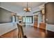Open dining area featuring dark wood table, woven chairs, and views to the living room with a fireplace at 204 Muirfield Ln, Clayton, NC 27527