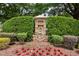 Stone community entrance sign amid manicured landscaping for Glen Laurel Golf Club at 204 Muirfield Ln, Clayton, NC 27527