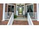 Inviting front entrance features brick steps, white railings, and a beautifully detailed glass door at 204 Muirfield Ln, Clayton, NC 27527
