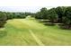 Aerial view of a golf course with lush green grass and tall trees at 204 Muirfield Ln, Clayton, NC 27527