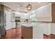 Bright kitchen featuring white cabinets, a stainless steel refrigerator, and granite countertops at 204 Muirfield Ln, Clayton, NC 27527