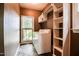 Laundry room has a washer and dryer, a window, and built-in shelving at 204 Muirfield Ln, Clayton, NC 27527