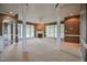 Bright living room with large windows, columns, neutral carpet, and a cozy fireplace at 204 Muirfield Ln, Clayton, NC 27527