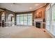Bright living room features a fireplace, ample natural light, and seamless flow to the kitchen at 204 Muirfield Ln, Clayton, NC 27527