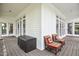 Outdoor living on porch featuring comfortable chairs with back cushions. Access to backyard and natural light at 204 Muirfield Ln, Clayton, NC 27527