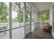 Relaxing screened porch with comfortable seating overlooking the backyard and lake beyond at 204 Muirfield Ln, Clayton, NC 27527