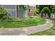 Green front yard with brick lattice decor and a paved walkway to the home at 204 Muirfield Ln, Clayton, NC 27527