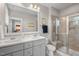 Modern bathroom with double vanity, framed mirror, and a tiled walk-in shower at 2070 Great Ridge Pkwy, Chapel Hill, NC 27516
