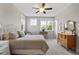 Bedroom featuring a bed, dresser, and multiple windows for ample natural light at 2070 Great Ridge Pkwy, Chapel Hill, NC 27516