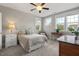 Comfortable bedroom with a ceiling fan, carpet, and multiple windows offering natural light at 2070 Great Ridge Pkwy, Chapel Hill, NC 27516