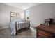 Cozy bedroom featuring soft gray walls, a charming metal bed frame, and gray carpeting at 2070 Great Ridge Pkwy, Chapel Hill, NC 27516