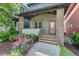 Charming home featuring a landscaped front yard with blooming pink roses and a welcoming covered porch entrance at 2070 Great Ridge Pkwy, Chapel Hill, NC 27516