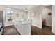 Bright kitchen island with a sink and a granite countertop, adjacent to a dining area at 2070 Great Ridge Pkwy, Chapel Hill, NC 27516