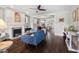 Stylish living room with a cozy fireplace, hardwood floors, and an open layout leading to the dining area at 2070 Great Ridge Pkwy, Chapel Hill, NC 27516
