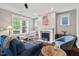 Inviting living room featuring hardwood floors, a fireplace, and ample natural light from the large windows at 2070 Great Ridge Pkwy, Chapel Hill, NC 27516