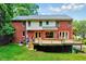 Home's backyard features a spacious deck, lush lawn and mature trees at 2109 W Marilyn Cir, Cary, NC 27513