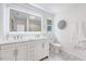 Clean bathroom with double sink vanity, white cabinets, and marble floors at 2109 W Marilyn Cir, Cary, NC 27513