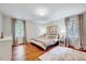 Inviting bedroom featuring hardwood floors, neutral tones, and natural light at 2109 W Marilyn Cir, Cary, NC 27513
