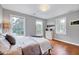 Cozy bedroom featuring hardwood floors, large windows, and soft, neutral decor at 2109 W Marilyn Cir, Cary, NC 27513
