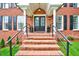 Inviting front porch with brick stairs and wrought iron railings at 2109 W Marilyn Cir, Cary, NC 27513