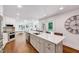 Spacious kitchen with a large island, white cabinets, stainless steel appliances, and hardwood floors at 2109 W Marilyn Cir, Cary, NC 27513