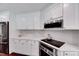 Well-appointed kitchen boasting white cabinets, stainless steel appliances, and modern backsplash at 2109 W Marilyn Cir, Cary, NC 27513