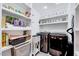 Well-organized laundry room with shelving, washer, and dryer at 2109 W Marilyn Cir, Cary, NC 27513