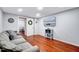 Cozy living room with a comfortable sofa, hardwood floors, and a TV for entertainment at 2109 W Marilyn Cir, Cary, NC 27513