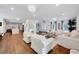Bright, open living room featuring hardwood floors, recessed lighting, and comfortable white upholstered seating at 2109 W Marilyn Cir, Cary, NC 27513